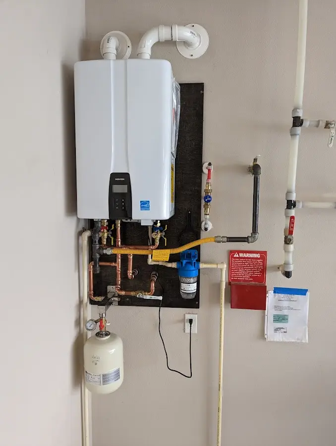 Professional plumber installing copper piping in a Monaca home